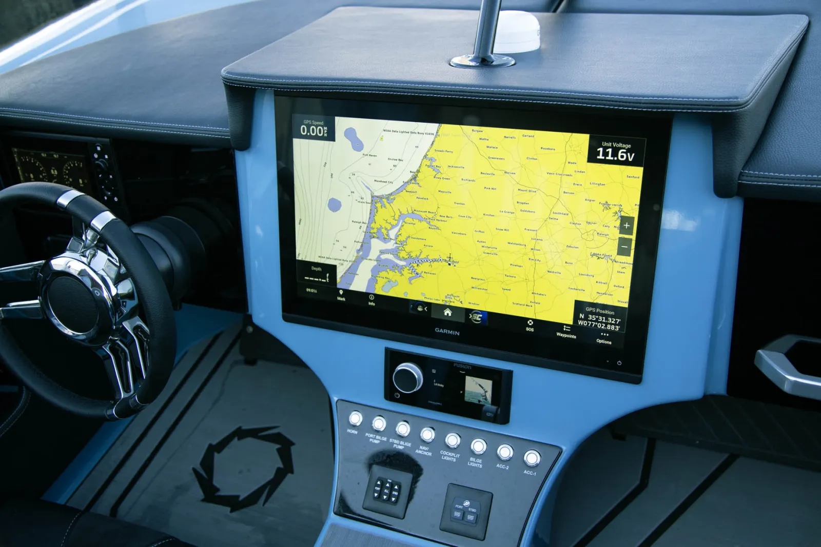 Cockpit featuring standard Garmin 8612 display with connected Mercury engine monitoring system and stainless steel push button switches with LED indicators