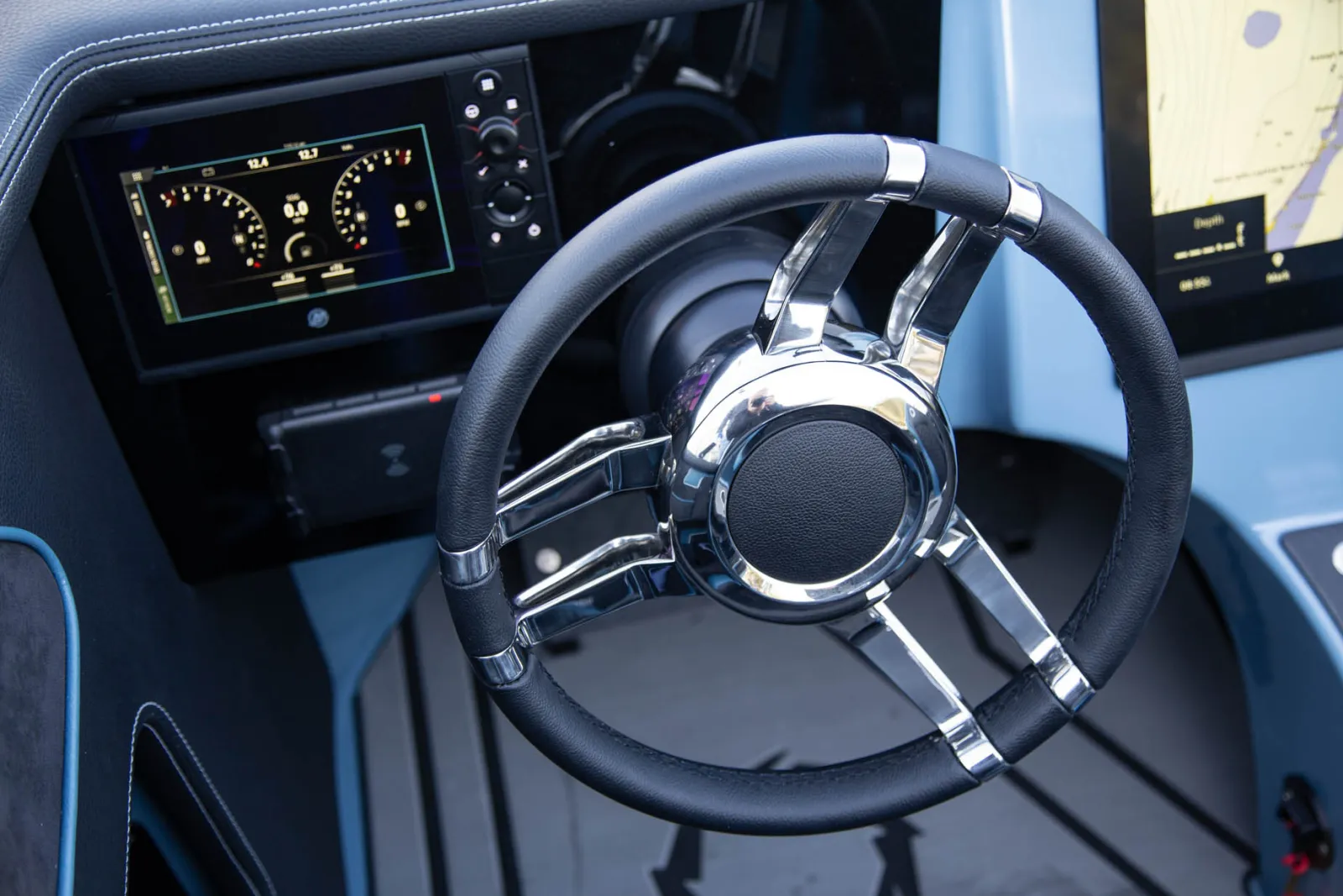 Steering wheel with custom Isotta Italian leather and stainless steel components, with portside console Mercury engine performance monitoring system