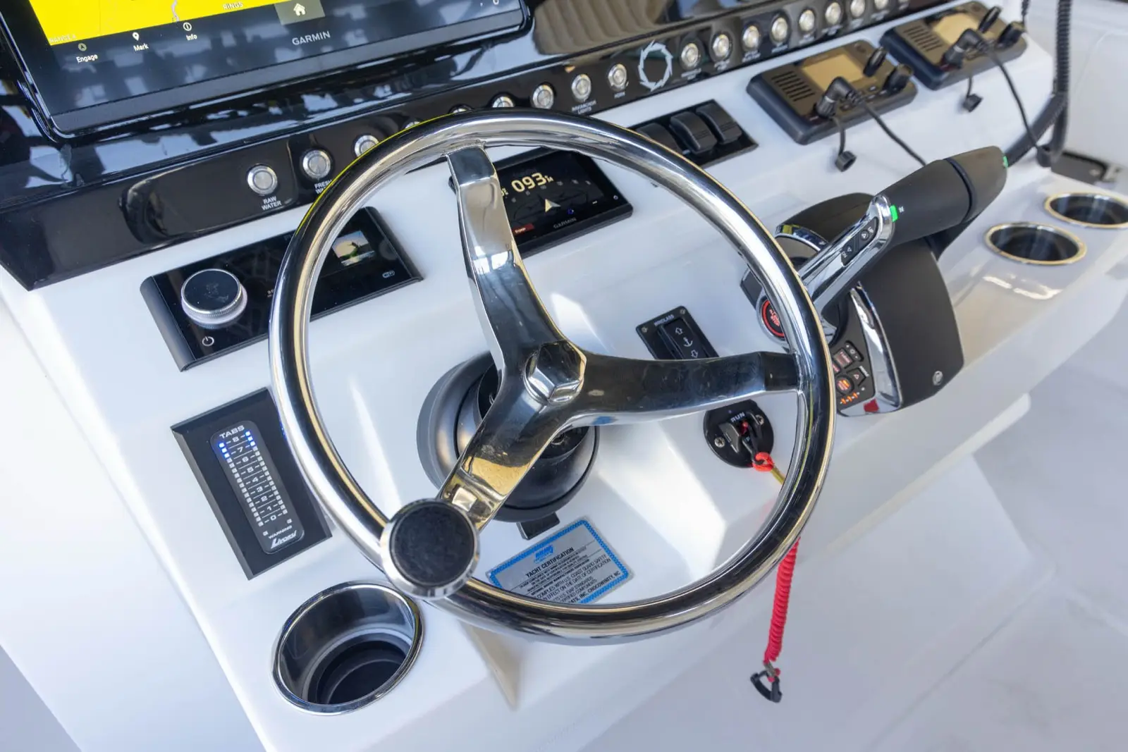 Stainless steel helm couples with Mercury hydraulic steering and LED trim tab control for comfortable and easy to reach adjustments while on plane at speed